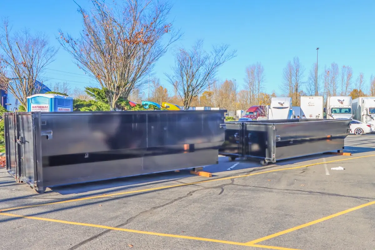 Professional dumpster rental service with roll-off container on residential driveway in Powell